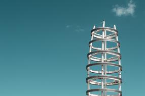 White steel structure at blue sky with white clouds
