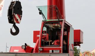 Load crane with the white and red hook