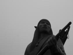 Sculpture of the Indian warrior, in Oklahoma City, America, under the cloudy sky