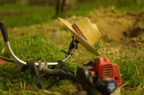 Straw Hat on Grass Cutting machine