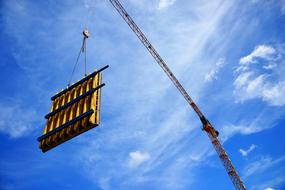 crane lifts the load at the construction site
