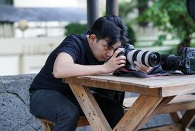 Photographer, asian man with Camera at table