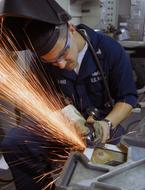 Construction worker in helmet, working with metal, with the tools