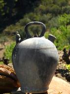 Beautiful Botijo in black pottery, near the green grass