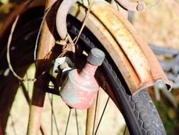 Wheel of the old, rusty "Dinamo" bike in light, outdoors