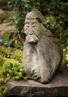 Beautiful, stone sculpture, near the green and yellow plants