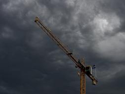 construction crane on the background of a stormy sky