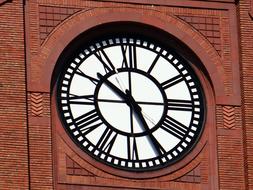 Beautiful, white and black clock, on the red brick building in Chicago, Illinois, USA