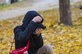 photographer in autumn park
