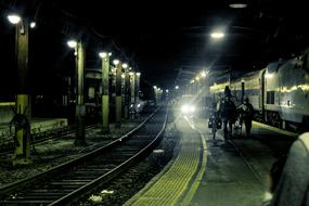 people at the train station at night