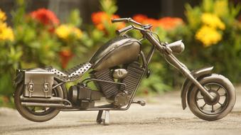 toy motorcycle in the garden on a blurred background