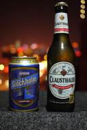 Beautiful, shiny beer can and bottle, at blurred background, in Stockholm, Sweden