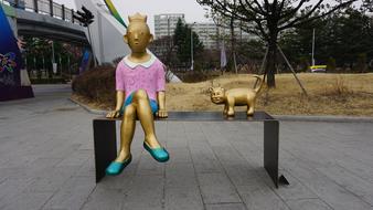 Sculpture of girl and cat in Park