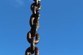 rusty metal chain on blue sky background