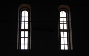 Windows of the building, with white light, among the darkness