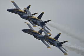 Flying blue angel planes in the cloudy sky