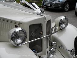 Beautiful, grey, shiny, vintage car with headlights