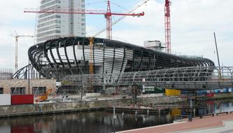 Climatehouse and cranes, in Bremerhaven, Germany, at blue sky with white clouds on background