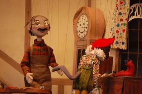 Colorful puppets, near the furniture, in the puppet theatre