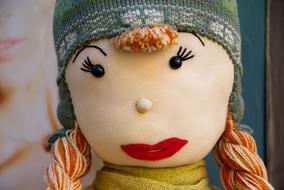 Cute, colorful and beautiful doll, with the braids, in hat