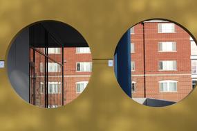 View on the beautiful brick building, through the holes, in winter