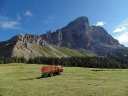 Red truck on the beautiful, green Dolomites in South Tyrol, Italy