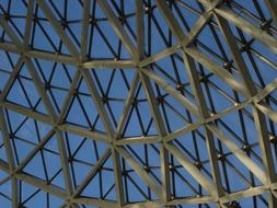 Patterned glass roof of the botanical garden, under the blue sky