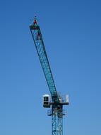 Top view of the crane, with the cabin, at blue sky on background