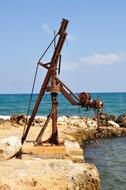 old rusty crane on seaside