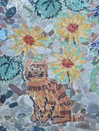 Beautiful and colorful mosaic with the cute cat, among the plants with flowers