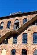 staircase on the facade of an old brick factory