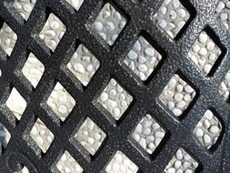 Shiny, black iron net on the texture