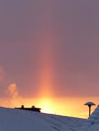 sunbeam at sunset over snowy landscape