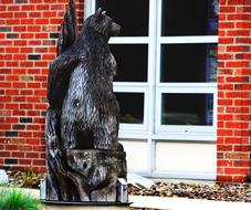 wooden sculpture of an animal near the house