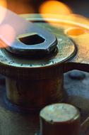 Close-up of the steel machine component in colorful, bokeh lights