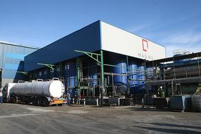 truck with tank and industrial building facade