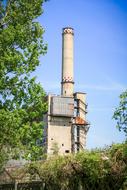 distant view of the old industrial tower among the trees