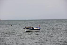 Colorful boat of the marine worker on the water with ripple