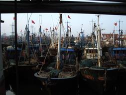 Boats with flags in the dock of the lake