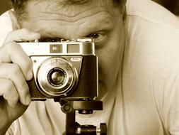 sepia, man with retro camera on tripod