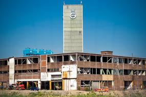 distant view of the facade of an old abandoned factory