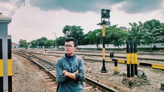 young man near the railroad