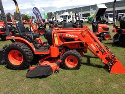 red tractors for mowing grass on a green field