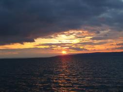 dramatic Sunset over dark sea and coastline