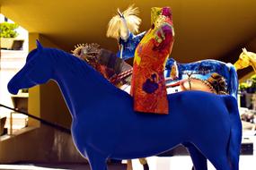 a work of art in the form of a blue horse with a rider