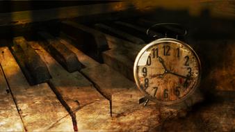 alarm clock on the background of old broken piano keys