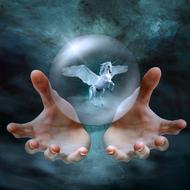 Beautiful, white Pegasus, flying in the bubble, above the hands, at background with beautiful turquoise sky with clouds