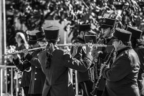 uniformed Musicians play wind instruments outdoor