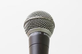 photo of a microphone against a white wall