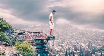 man stands on edge of cliff above misty city, digital art